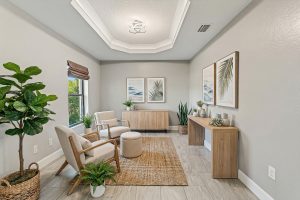 Modern living room with beige armchairs, wooden furniture, potted plants, and botanical wall art.